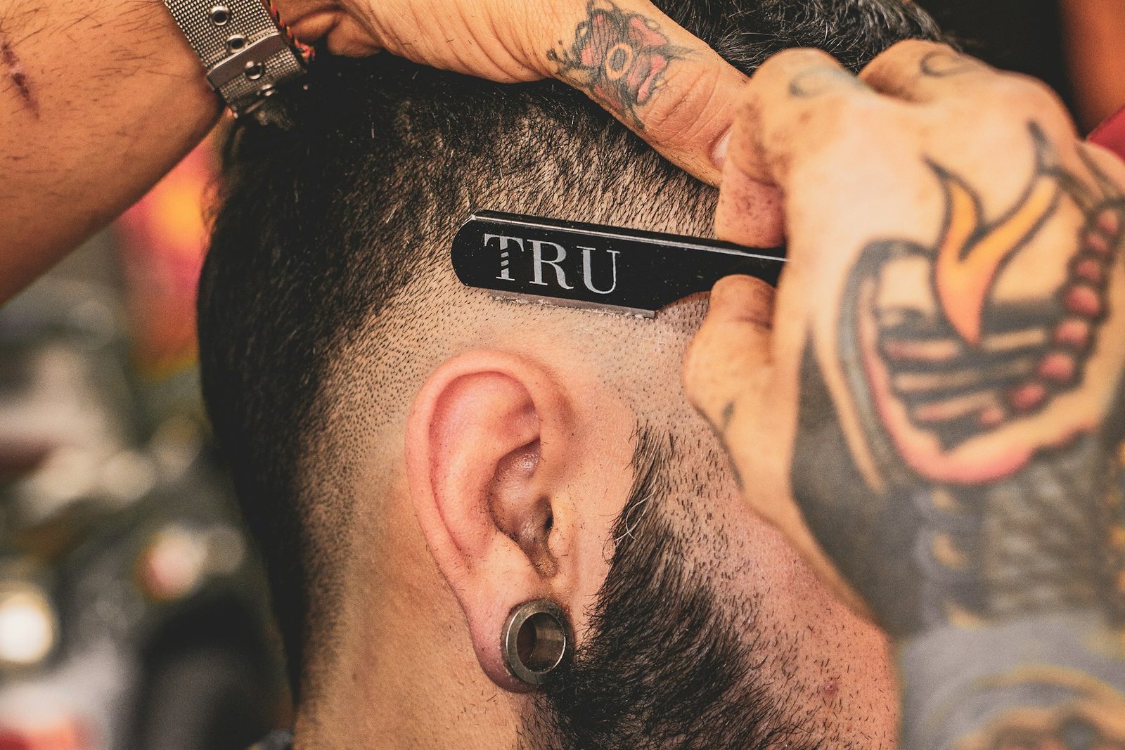 Barber cutting hair with clippers