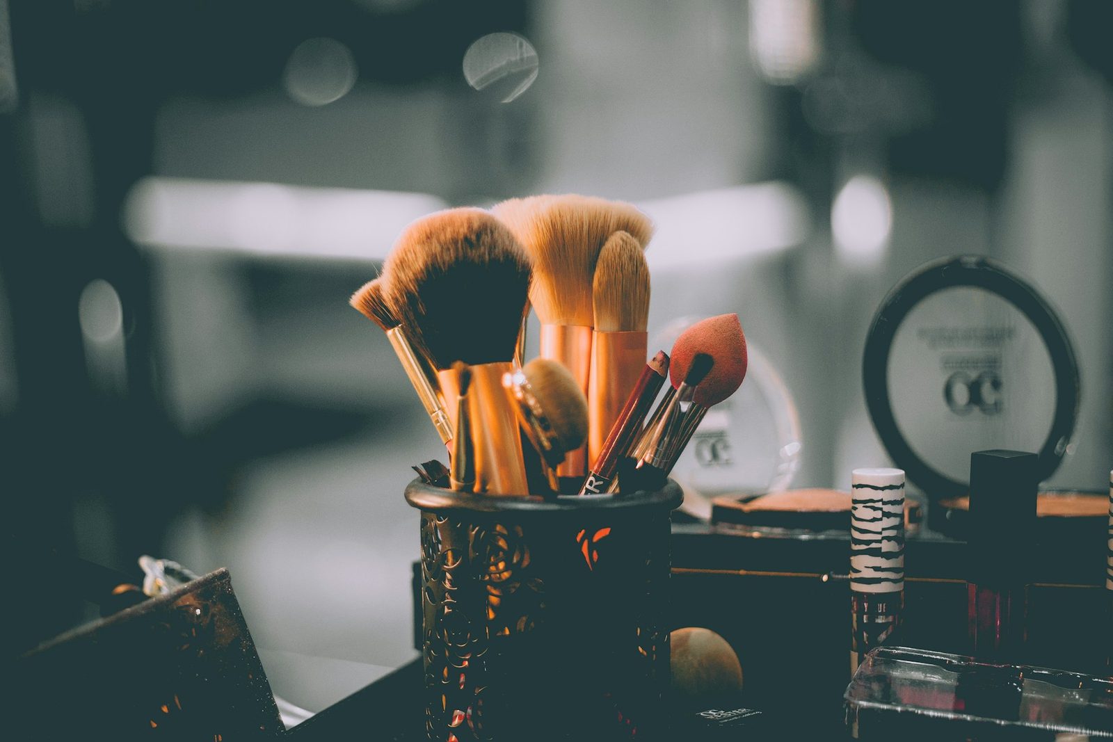 Makeup brushes and beauty tools on a studio counter