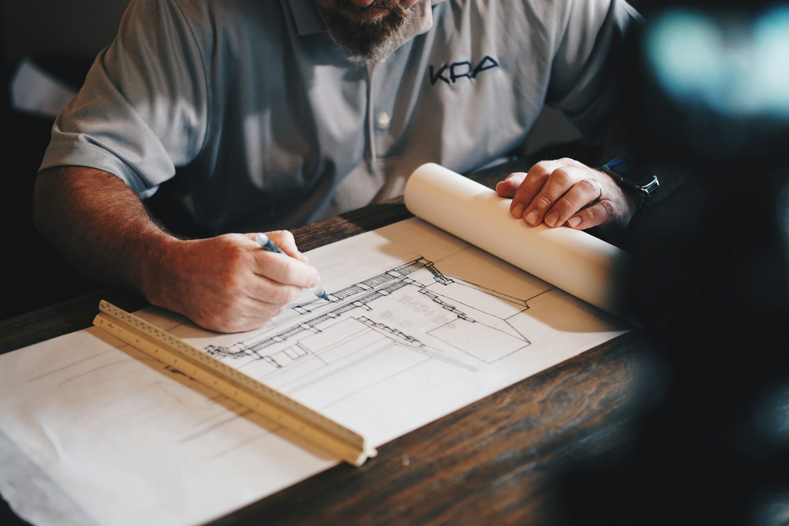 Builder drawing on construction plans