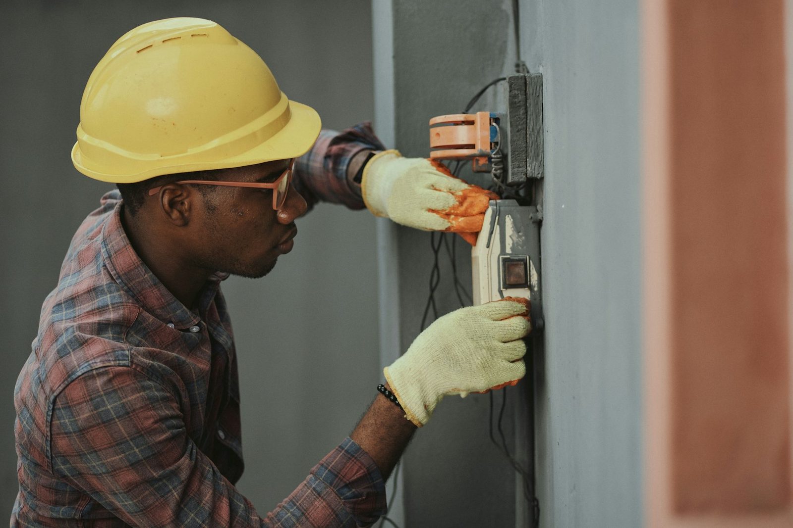 Licensed electrician working at an electrical panel